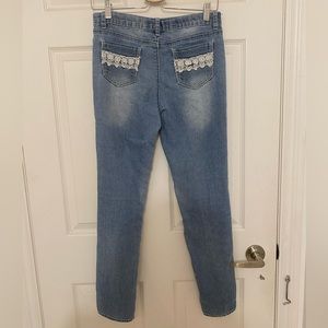 Straight-leg jeans with cute white lace detail on front and back pockets
